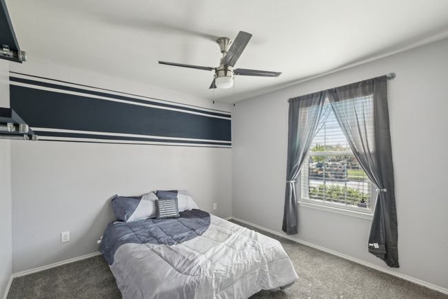 Carpeted bedroom featuring baseboards and ceiling fan | Image 15