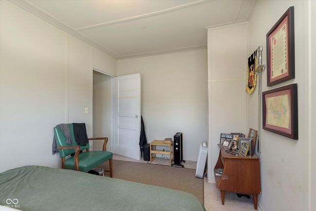 bedroom with light carpet and ornamental molding | Image 18