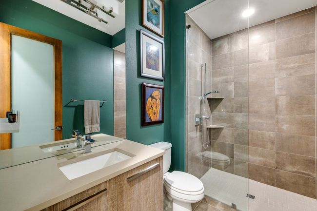 Full bath featuring a tile shower and vanity | Image 6