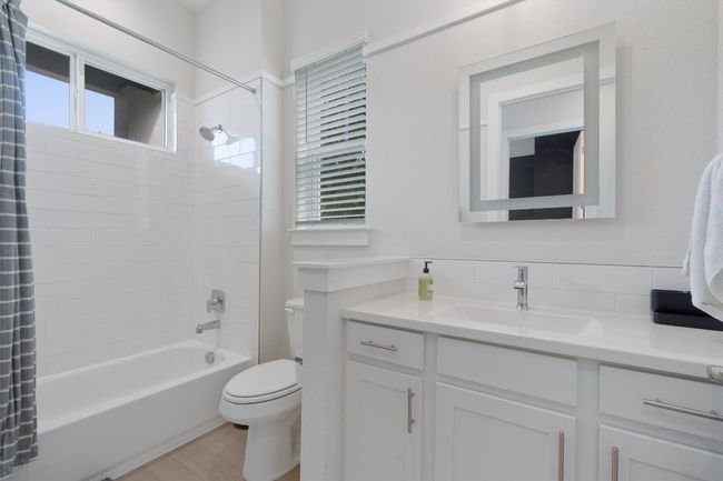 Bathroom featuring vanity, shower / bath combo with shower curtain, and wood finished floors | Image 33