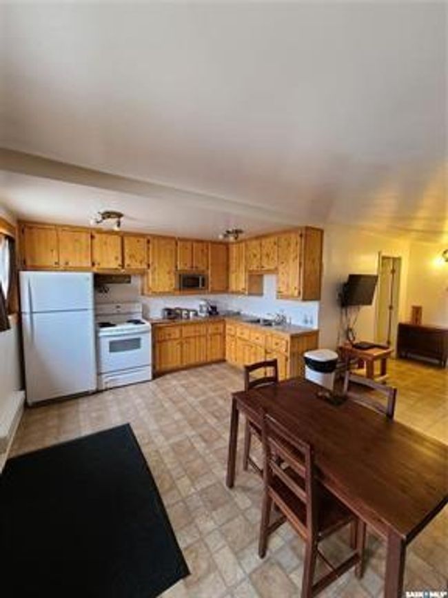 Kitchen featuring light tile patterned flooring and white appliances | Image 39