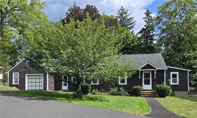 View of front of property with a garage and a front lawn | Image 1