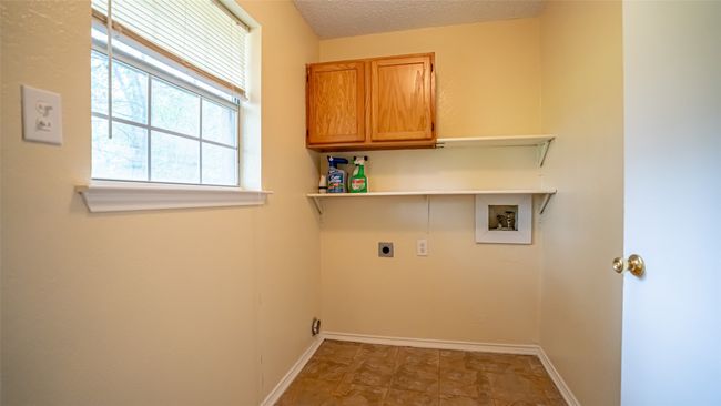 Laundry room featuring washer hookup, electric dryer hookup, cabinet space, baseboards, and a textured ceiling | Image 18
