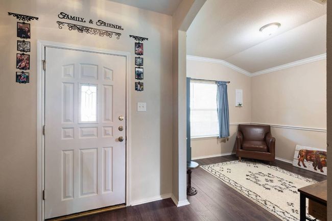 Foyer entrance featuring ornamental molding, dark wood finished floors, vaulted ceiling, and arched walkways | Image 12