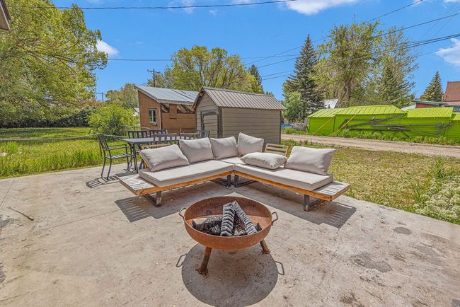 View of patio / terrace featuring an outdoor fire pit | Image 36