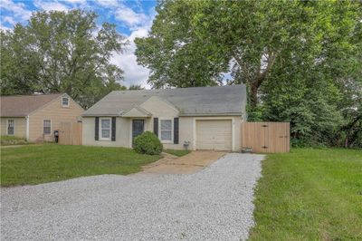 Single story home featuring a garage and a front lawn | Image 2