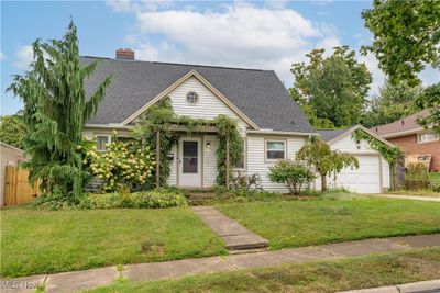 View of front of home with a garage and a front lawn | Image 1