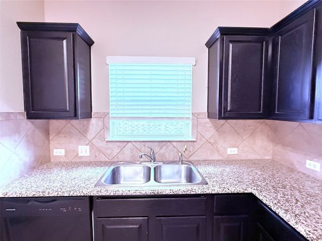 Kitchen featuring dishwasher, light countertops, and decorative backsplash | Image 7