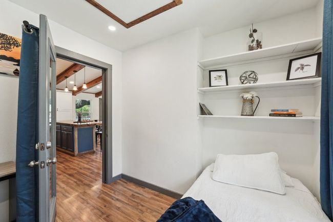 Bedroom with wood finished floors, recessed lighting, and baseboards | Image 16