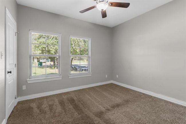 Carpeted spare room with a ceiling fan and baseboards | Image 8