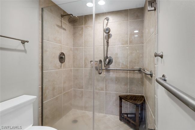 Bathroom featuring a shower with shower door and toilet | Image 20
