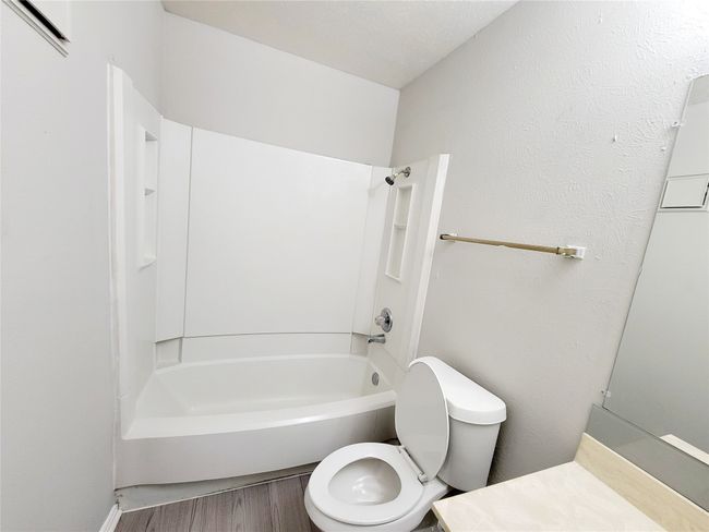 Bathroom with hardwood / wood-style floors, toilet, and bathing tub / shower combination | Image 20