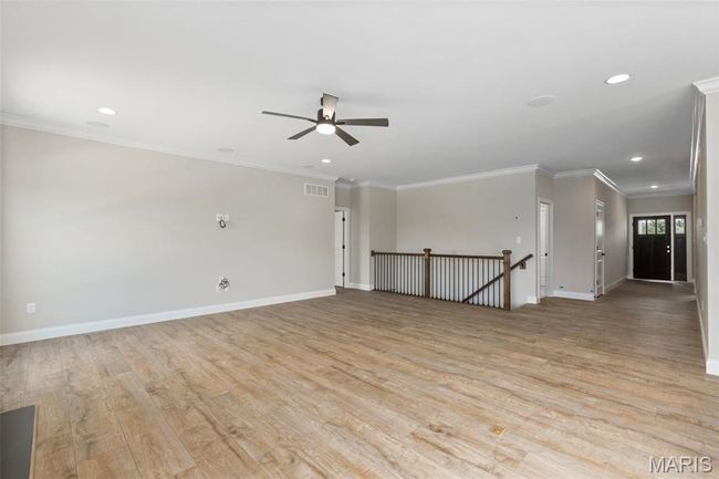 Unfurnished living room featuring recessed lighting, light wood finished floors, ceiling fan, baseboards, and crown molding | Image 7