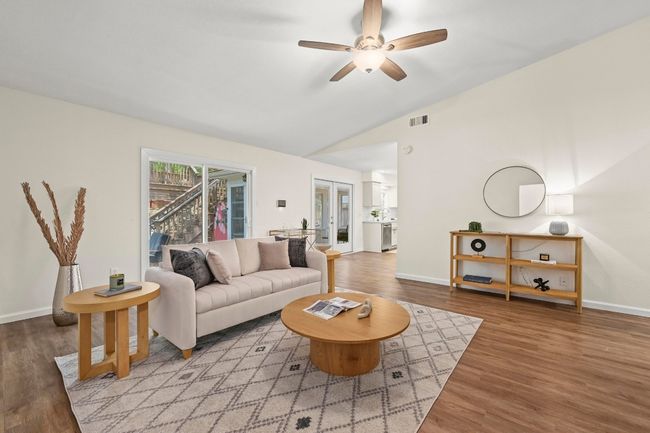 The living room feels bright and open thanks to perectly placed sliders that access the backyard retreat. | Image 7