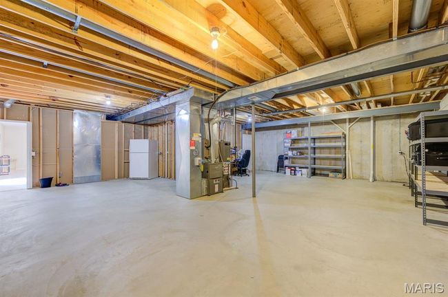 Unfinished below-grade area featuring HVAC in the center and an immense area for storage. | Image 35