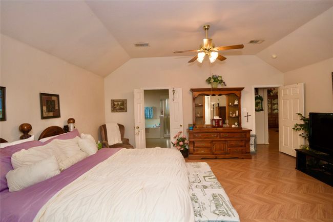 Primary Bedroom featuring vaulted ceiling and ceiling fan | Image 10