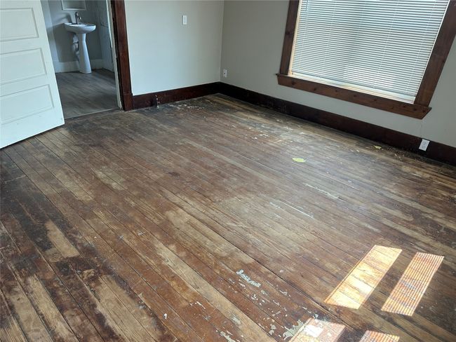 Spare room featuring a sink, hardwood / wood-style flooring, and baseboards | Image 12