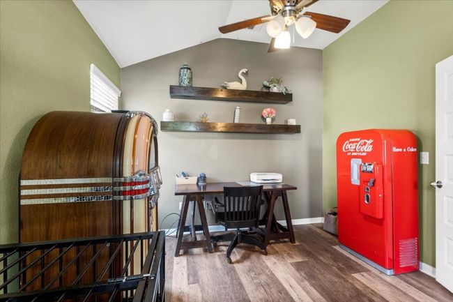 Home office with wood finished floors, ceiling fan, vaulted ceiling, and baseboards | Image 5