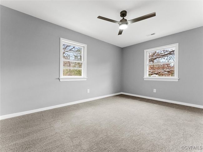 Spare room with carpet floors, a wealth of natural light, visible vents, and baseboards | Image 27