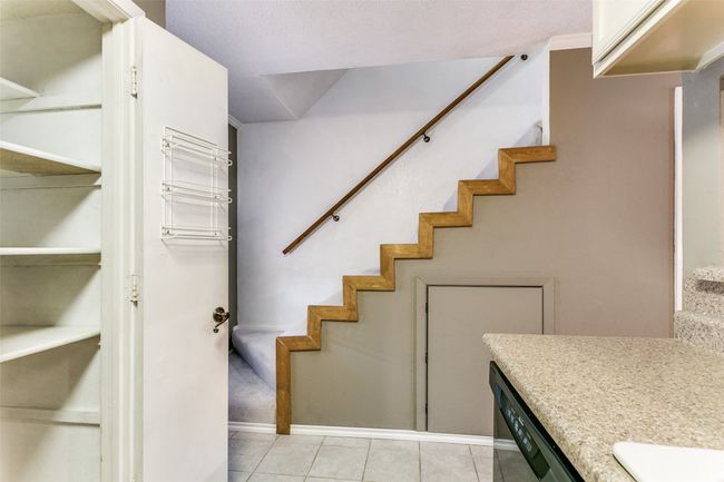 Stairs with tile patterned flooring and baseboards | Image 16