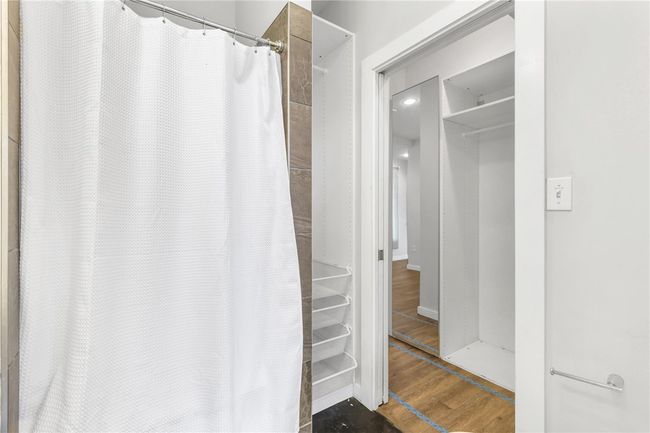 Full bath featuring wood finished floors and a shower with curtain | Image 31