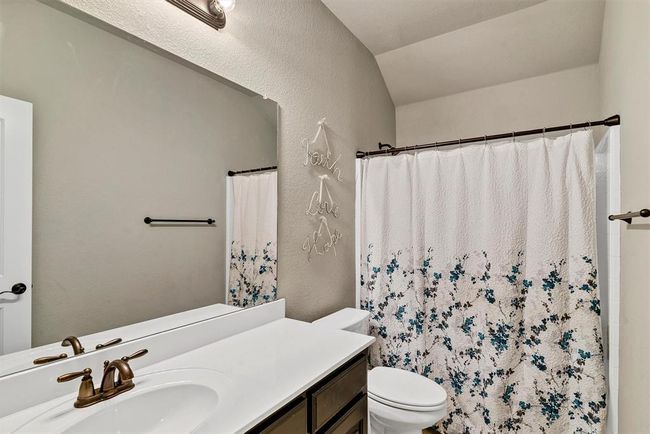 Bathroom featuring vanity with extensive cabinet space and toilet | Image 25