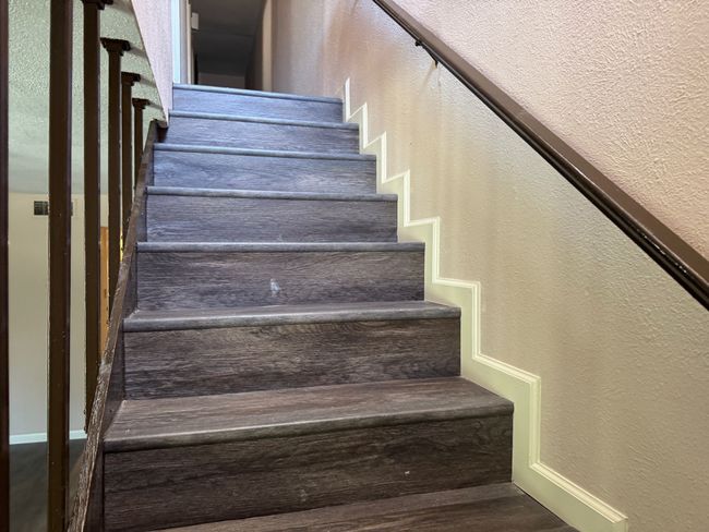 Staircase featuring a textured wall and baseboards | Image 10