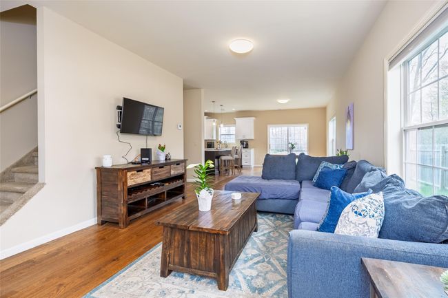 Living area featuring baseboards, wood finished floors, and stairway | Image 7
