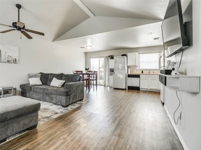 Living room with sink, lofted ceiling, ceiling fan, and light wood-type flooring | Image 2