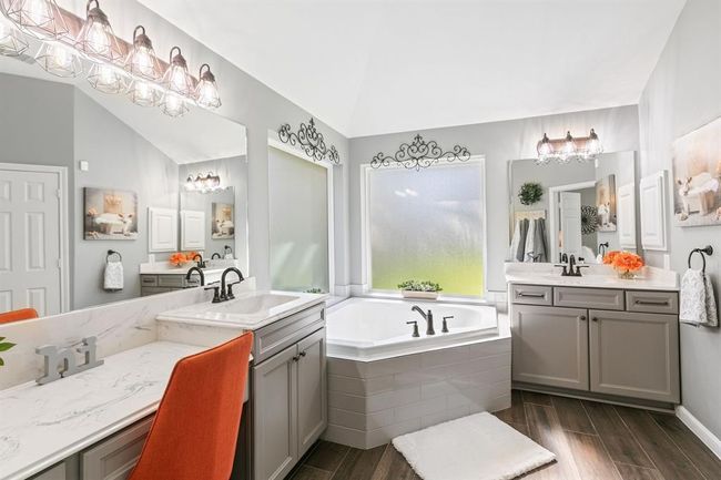 The dual vanities, large mirrors, walk in shower and corner bath tub will certainly enhance your morning and nightly routine. | Image 26