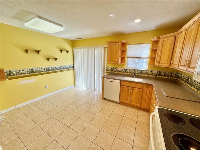 Kitchen with sliding door to the covered patio. | Image 8