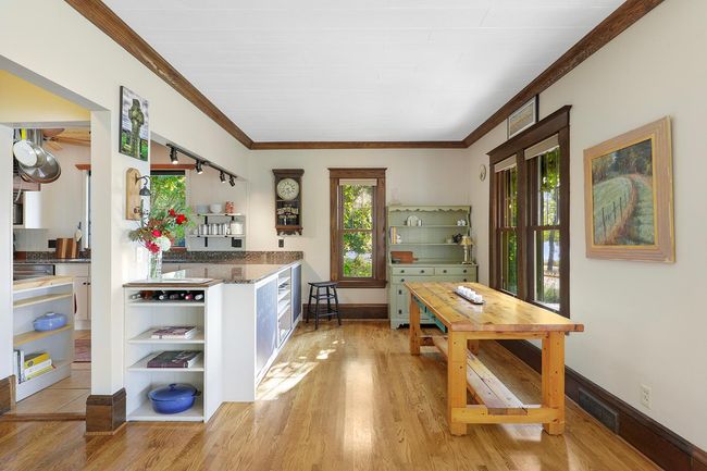 Kitchen/Dining shares gleaming wood floors throughout home. | Image 7