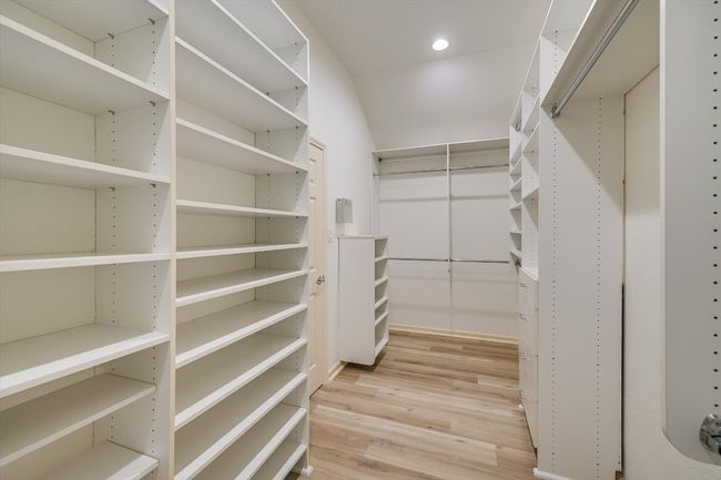 Walk in closet featuring light wood-type flooring | Image 27