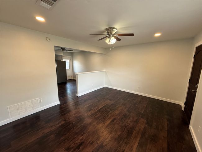 Unfurnished room featuring ceiling fan, dark wood-style floors, and recessed lighting | Image 4