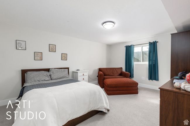 Bedroom with light carpet and baseboards | Image 31