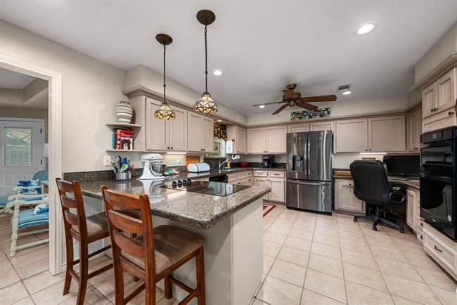 Updated Kitchen with Granite Countertops and Breakfast Bar | Image 10