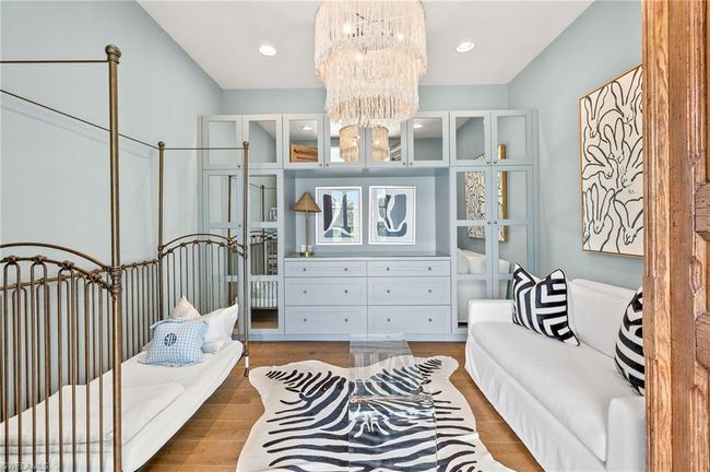 Bedroom featuring wood finished floors, a chandelier, and recessed lighting | Image 29