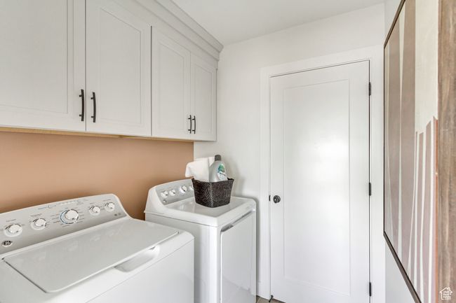 Washroom featuring washer and clothes dryer and cabinet space | Image 11