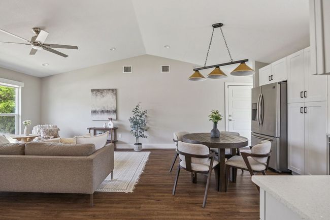 Living room featuring lofted ceiling, dark wood finished floors, and ceiling fan | Image 9