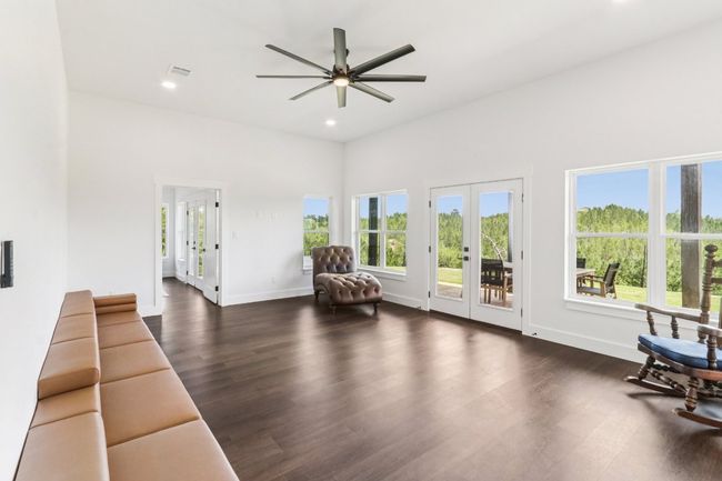 Living area with a ceiling fan, french doors, dark wood-style flooring, and recessed lighting | Image 33