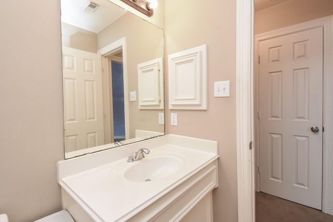 This 6' x 8' secondary bathroom comes equipped with a white vanity to store toiletries, updated modernlight fixtures, big mirror and shower/tub combo. | Image 26
