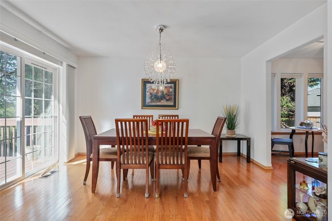 Dining room off of main living space. Sliding glass door leads to a freshly painted deck for entertaining. | Image 12