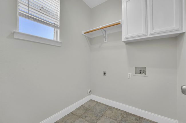 Laundry area with cabinet space, washer hookup, and electric dryer hookup | Image 17