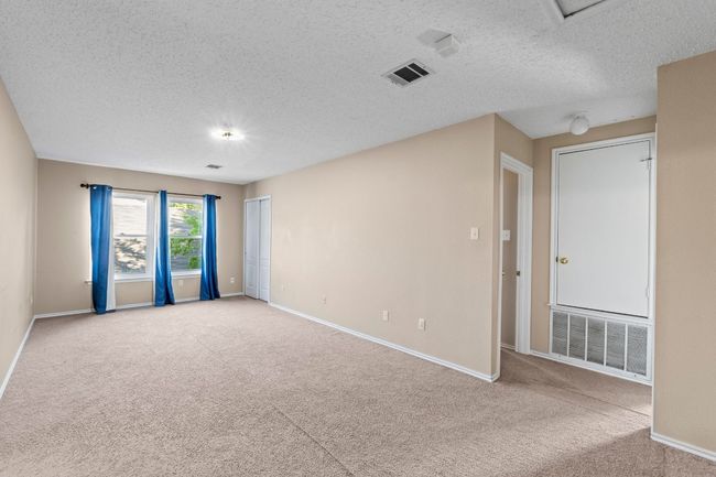 Spare room with carpet, baseboards, and a textured ceiling | Image 16