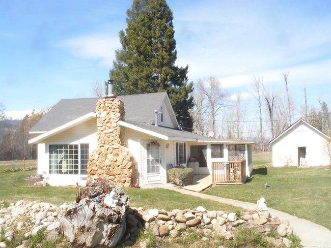 View of front of home featuring a sunroom, a front lawn, and a chimney | Image 25