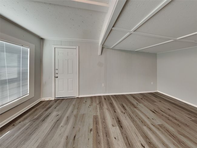 Empty room with wood finished floors and baseboards | Image 13