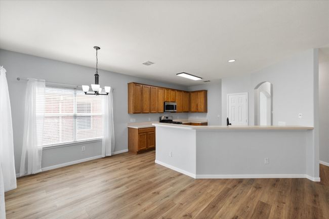 Unfurnished dining area with chandelier and NEW light laminate flooring | Image 16