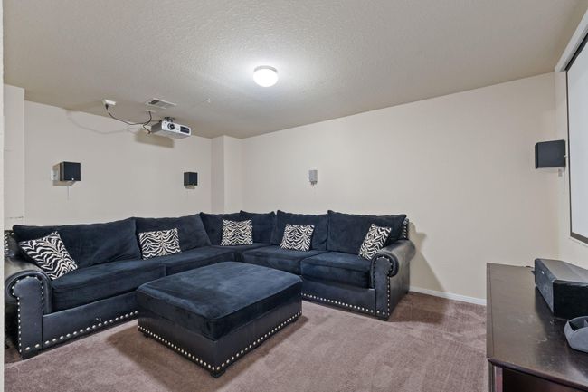 Just off the game room is the media room. Projector and screen are staying with the home! | Image 29