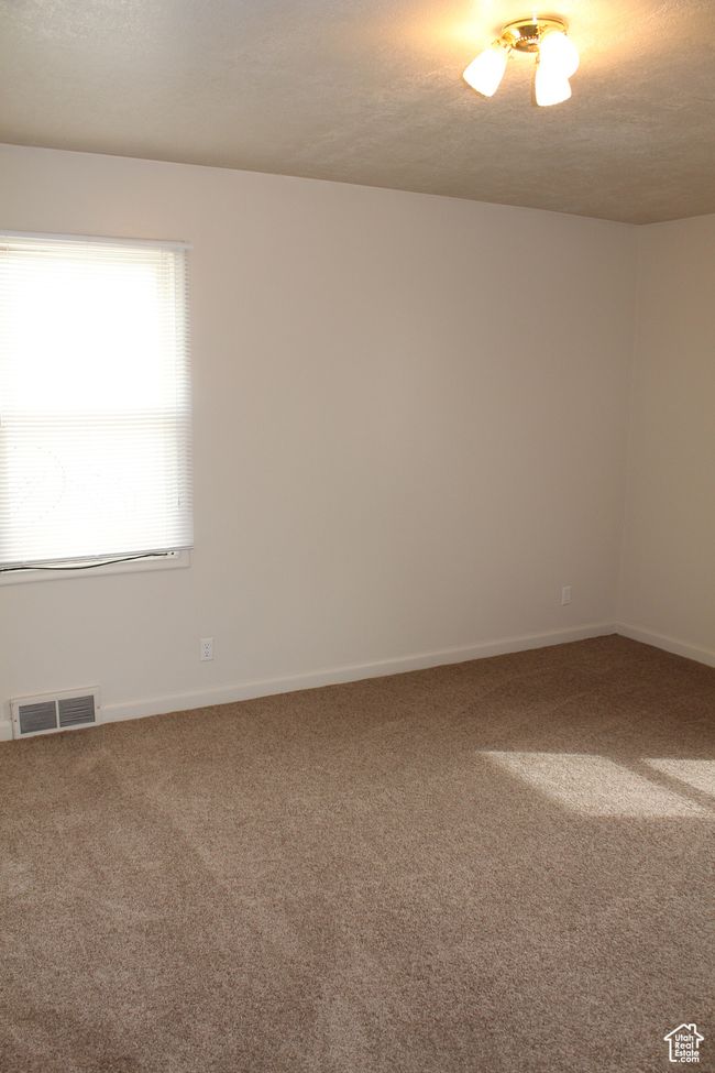 Empty room featuring carpet flooring and a textured ceiling | Image 10