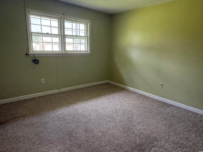 Unfurnished room with a textured ceiling, baseboards, and carpet flooring | Image 7